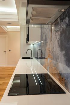 Home Sleek and modern kitchen with minimalist design and contemporary appliances.